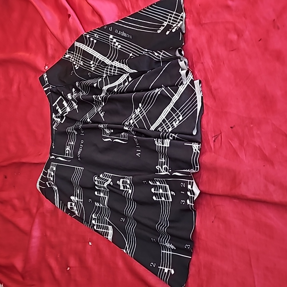 Brand new short skirt with music notes printed on it.